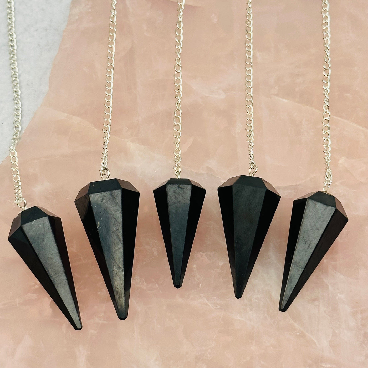 multiple Shungite Pendulums displayed to show the differences in the sizes
