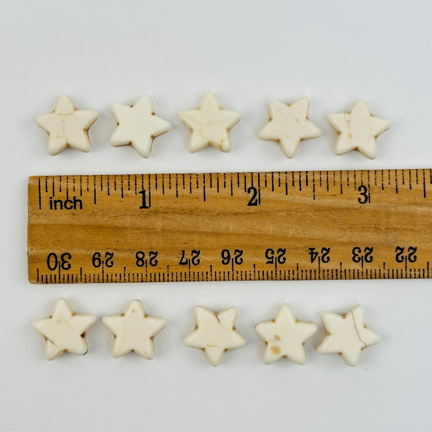 star beads displayed next to a ruler for size reference 