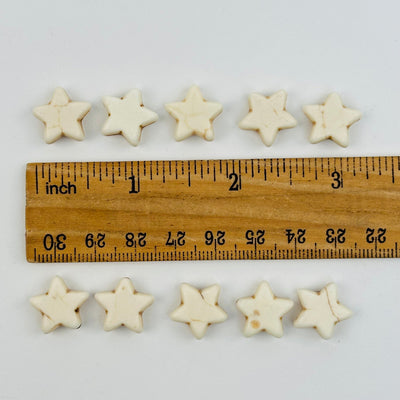 star beads displayed next to a ruler for size reference 