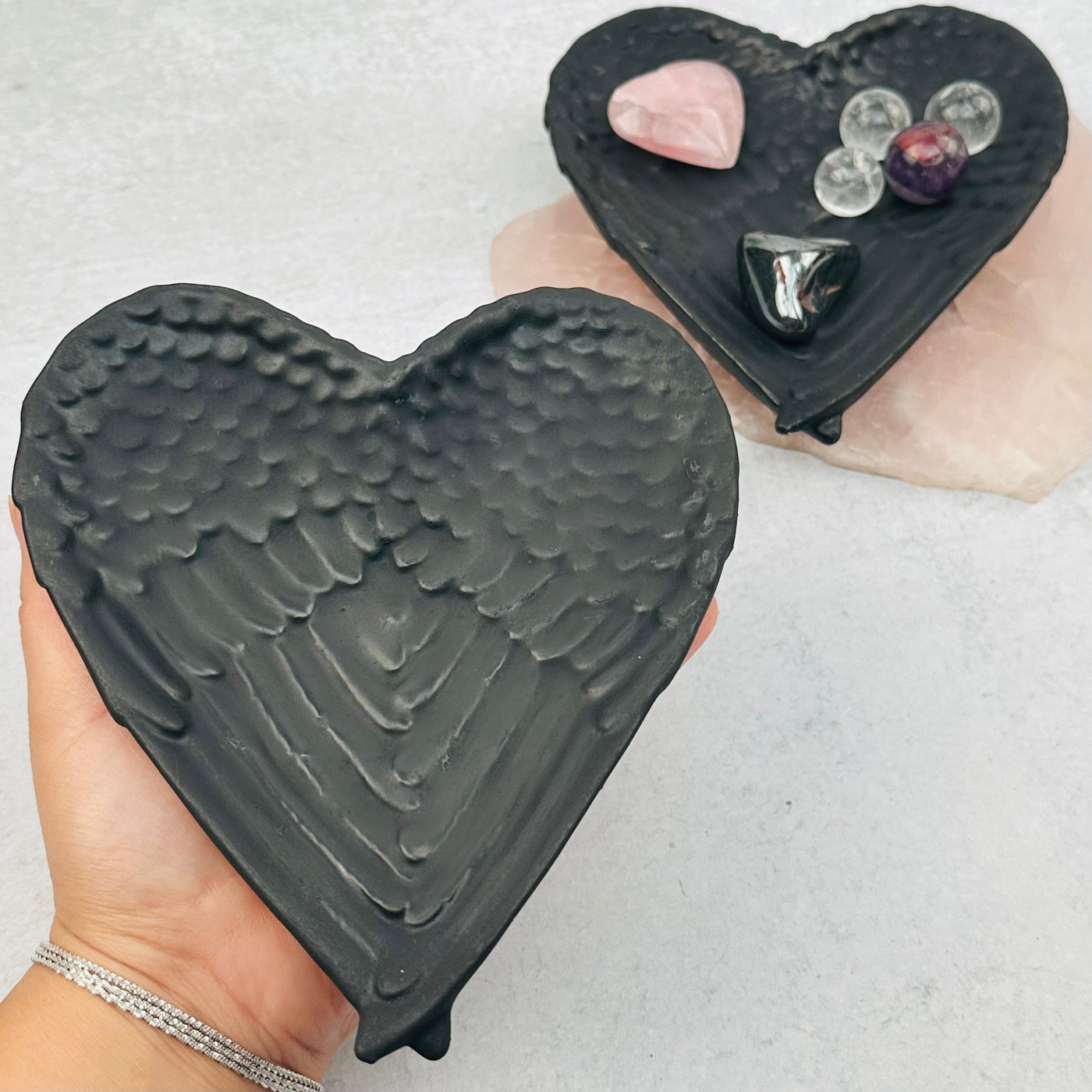Shungite Angel Wings Heart Bowl in hand for size reference 