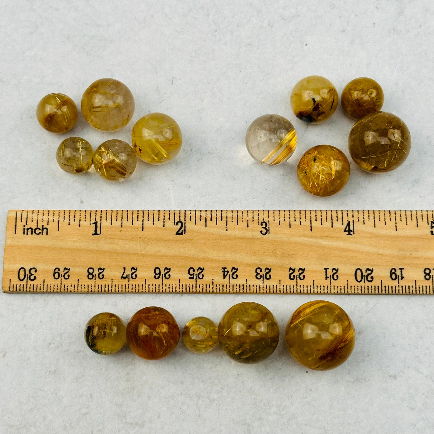 spheres next to a ruler for size reference 