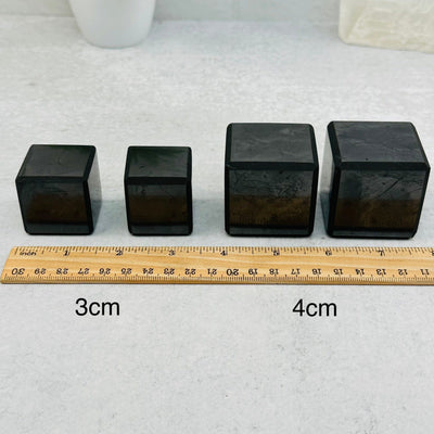 Shungite Cubes - 3cm or 4cm - next to a ruler for size reference 