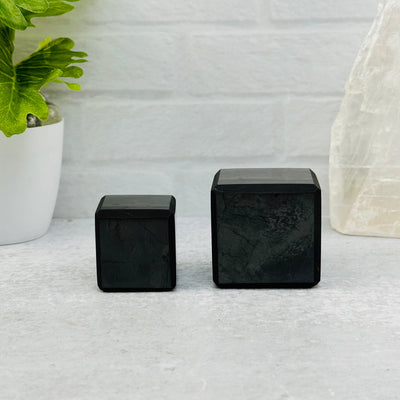 3cm and 4cm cubes next to each other to show the differences in the sizes 