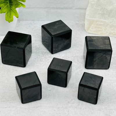 multiple shungite cubes displayed to show the differences in the sizes available 