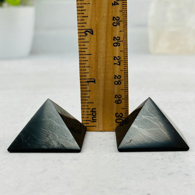 Shungite Pyramids next to a ruler for size reference 