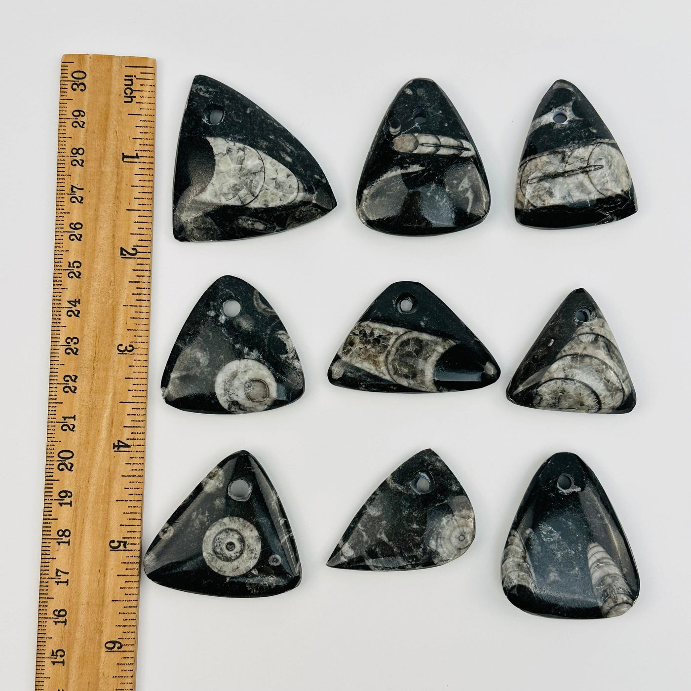 beads displayed next to a ruler for size reference 