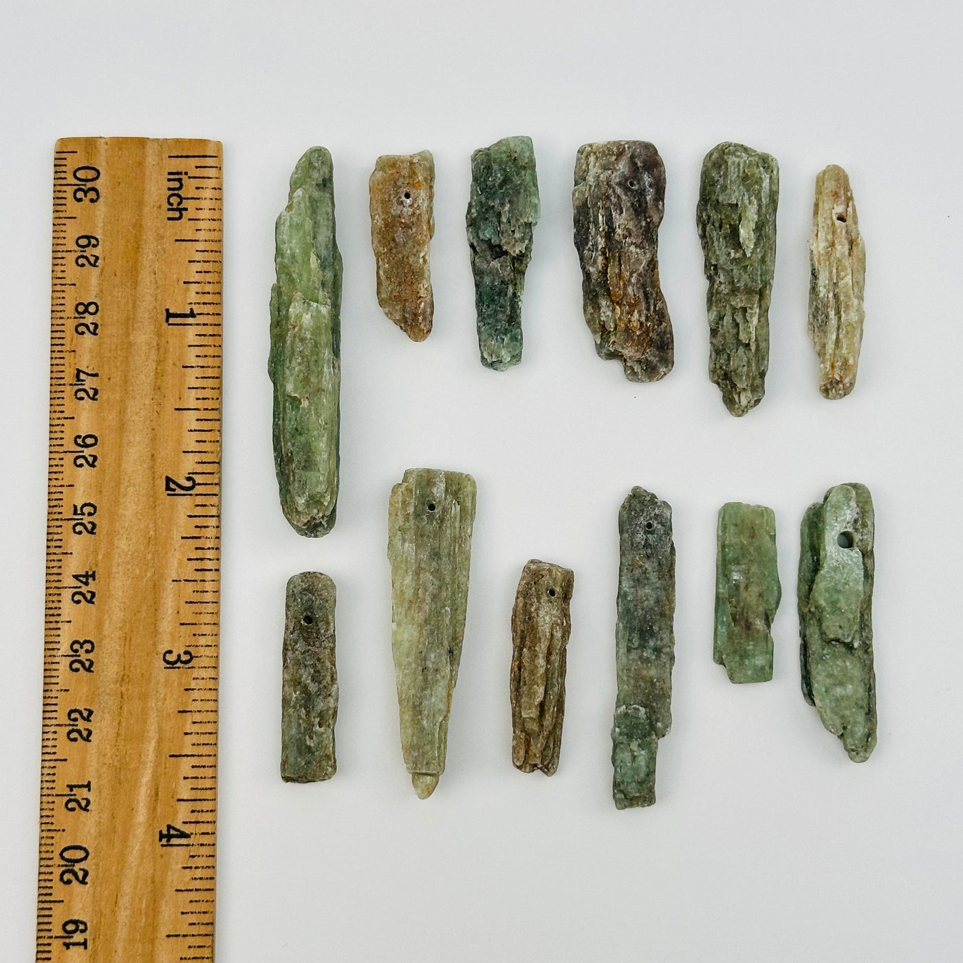 Green Kyanite Free Form Crystal Beads displayed next to a ruler for size reference 