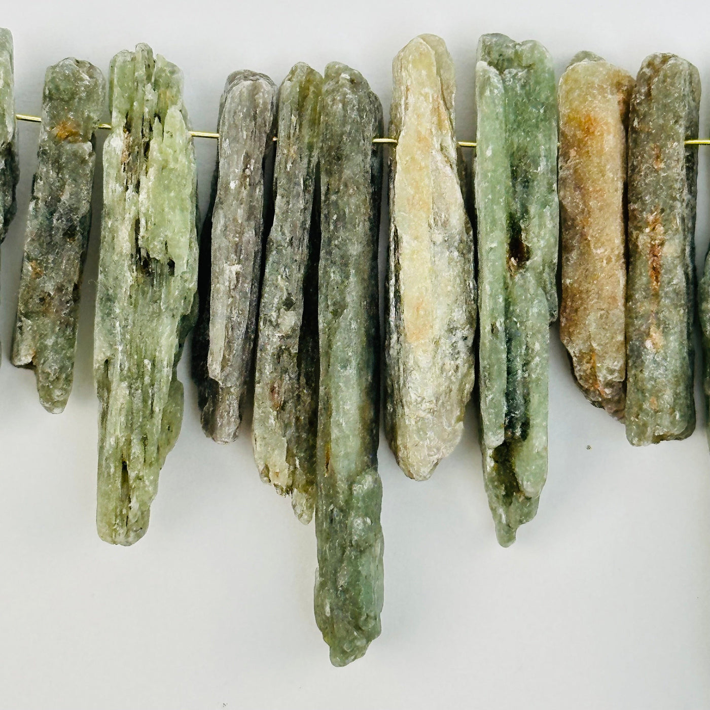 close up of the details on these green kyanite crystal beads 
