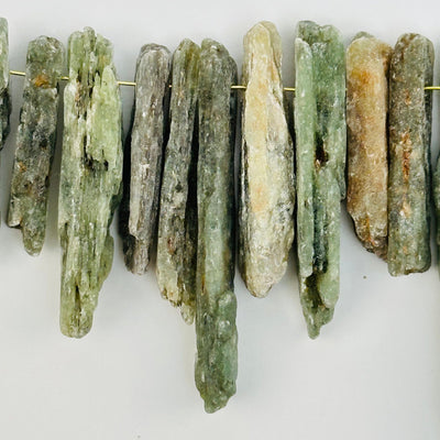 close up of the details on these green kyanite crystal beads 