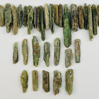 multiple Green Kyanite Free Form Crystal Beads displayed to show the differences in the sizes and color shades  