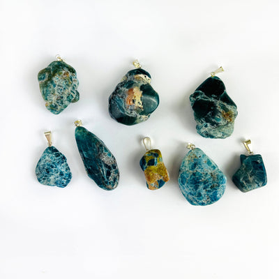 Apatite Polished Freeform Crystal Pendants with Silver Bails on a table showing various sizes