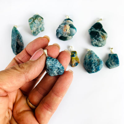 Apatite Polished Freeform Crystal Pendant with Silver Bail in a hand for size reference