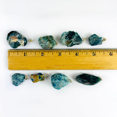 Apatite Polished Freeform Crystal Pendants with Silver Bails next to a ruler for size reference