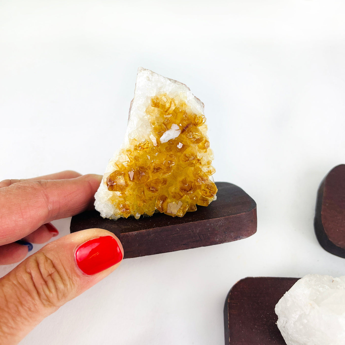up close of the citrine cluster on wood base