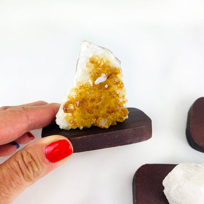 up close of the citrine cluster on wood base
