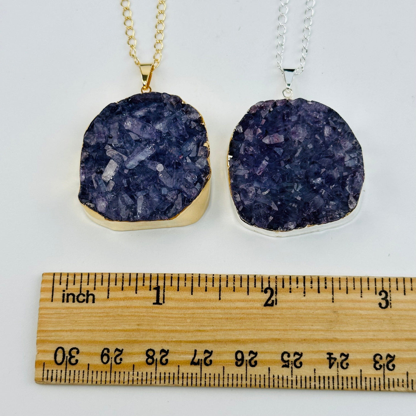 amethyst pendant next to a ruler for size reference 