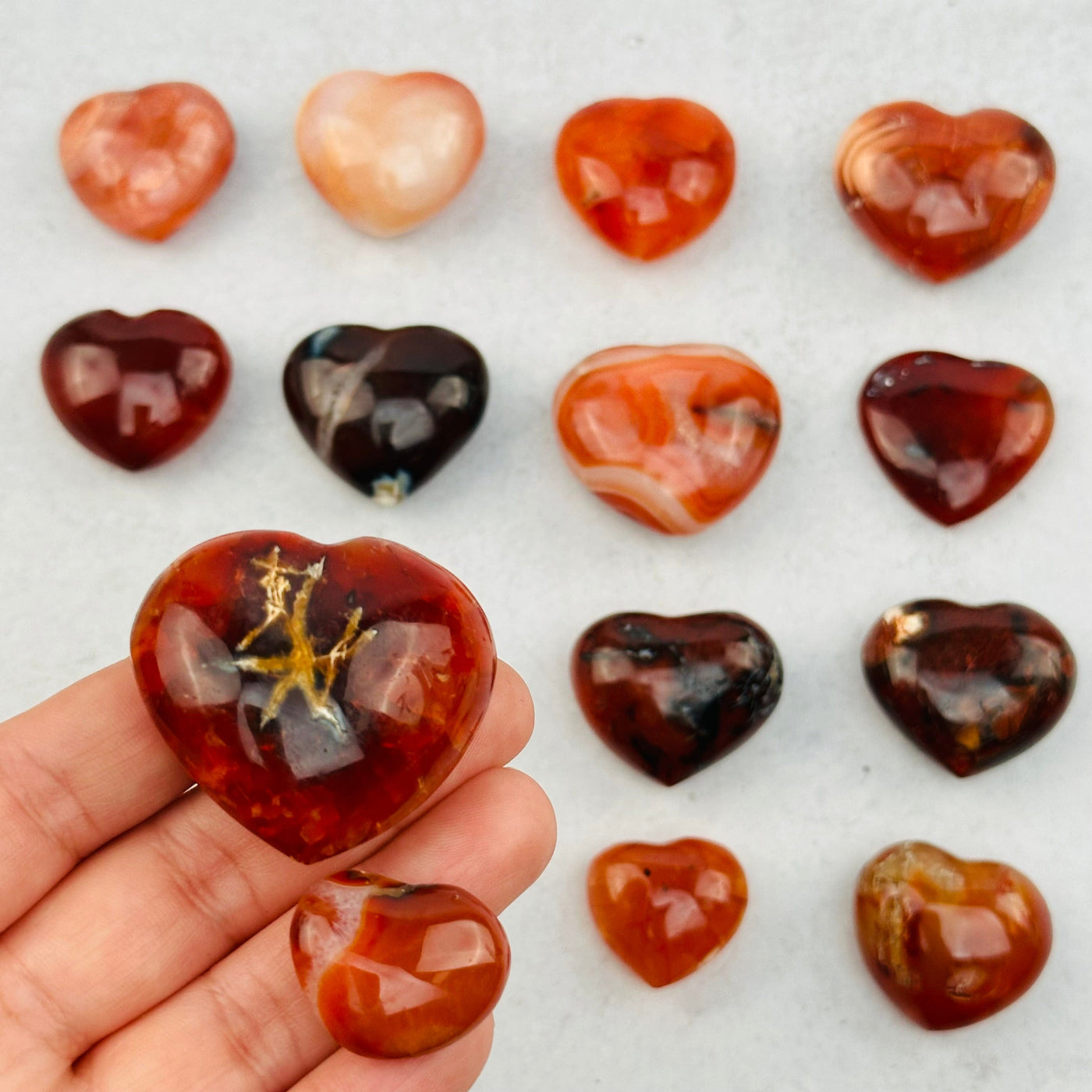 Carnelian Hearts in hand for size reference 