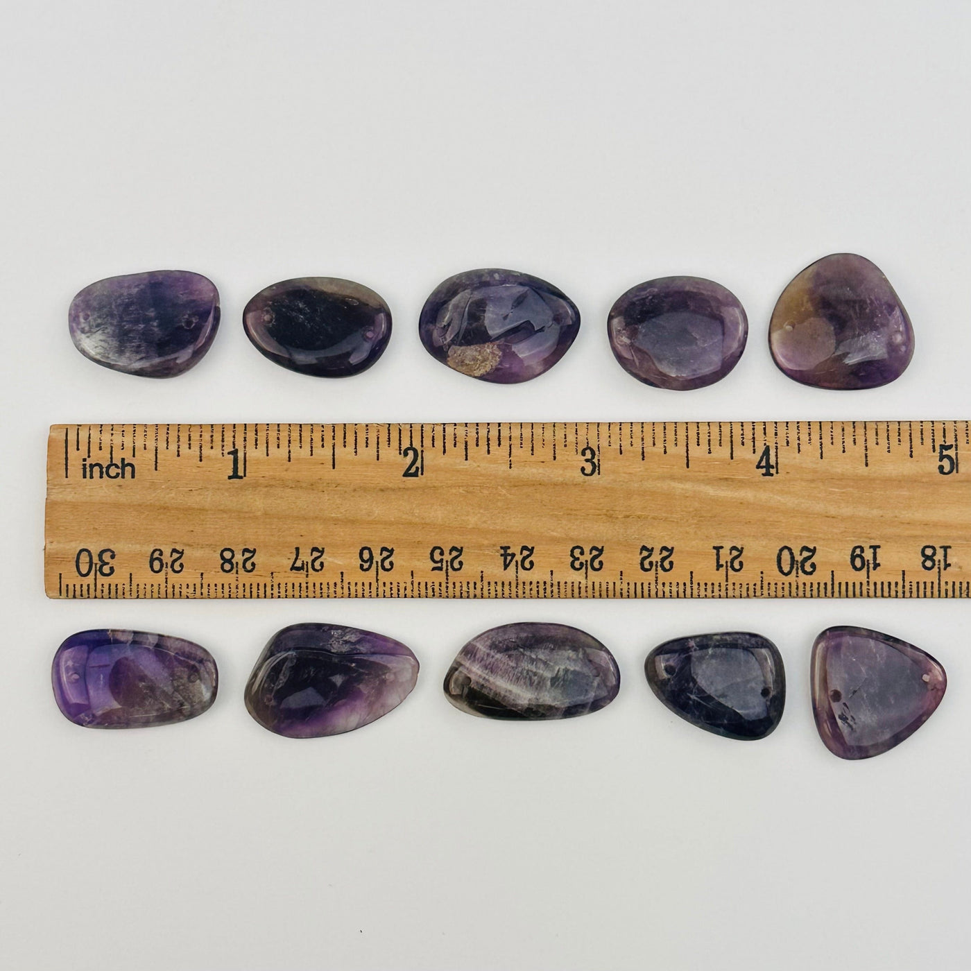 beads displayed next to a ruler for size reference 