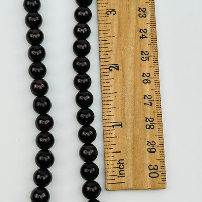 close up of the beads next to a ruler for sizing 