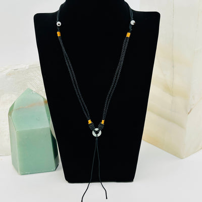 Jade Ring Crystal Necklace displayed to show how it hangs. comes with an extra string to for adding a personal pendant 