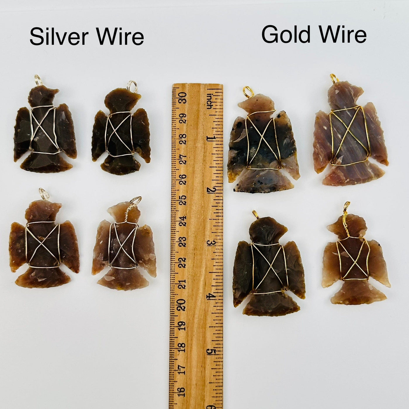 pendants displayed next to a ruler for size reference. available in silver or gold toned wire wrapping 