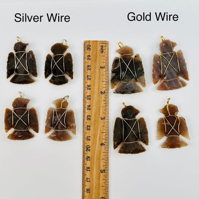 pendants displayed next to a ruler for size reference. available in silver or gold toned wire wrapping 