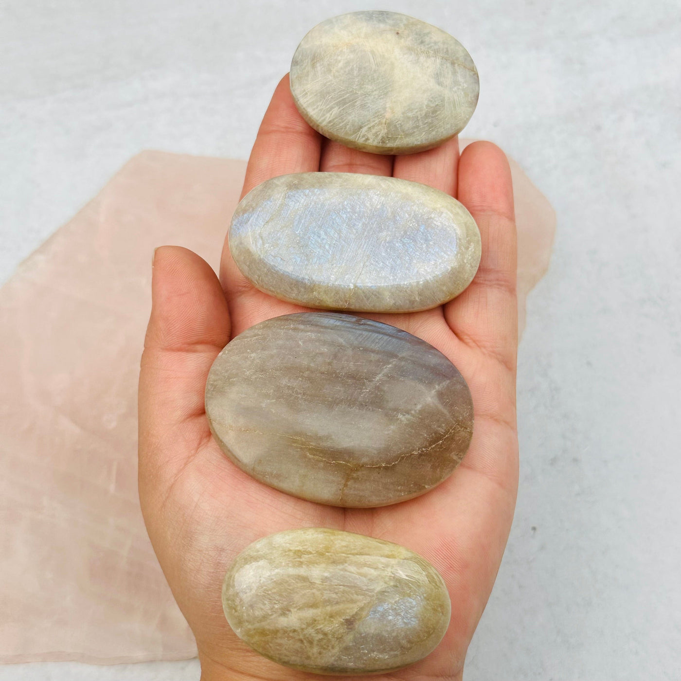 palm stones in hand to show the differences in the sizes 