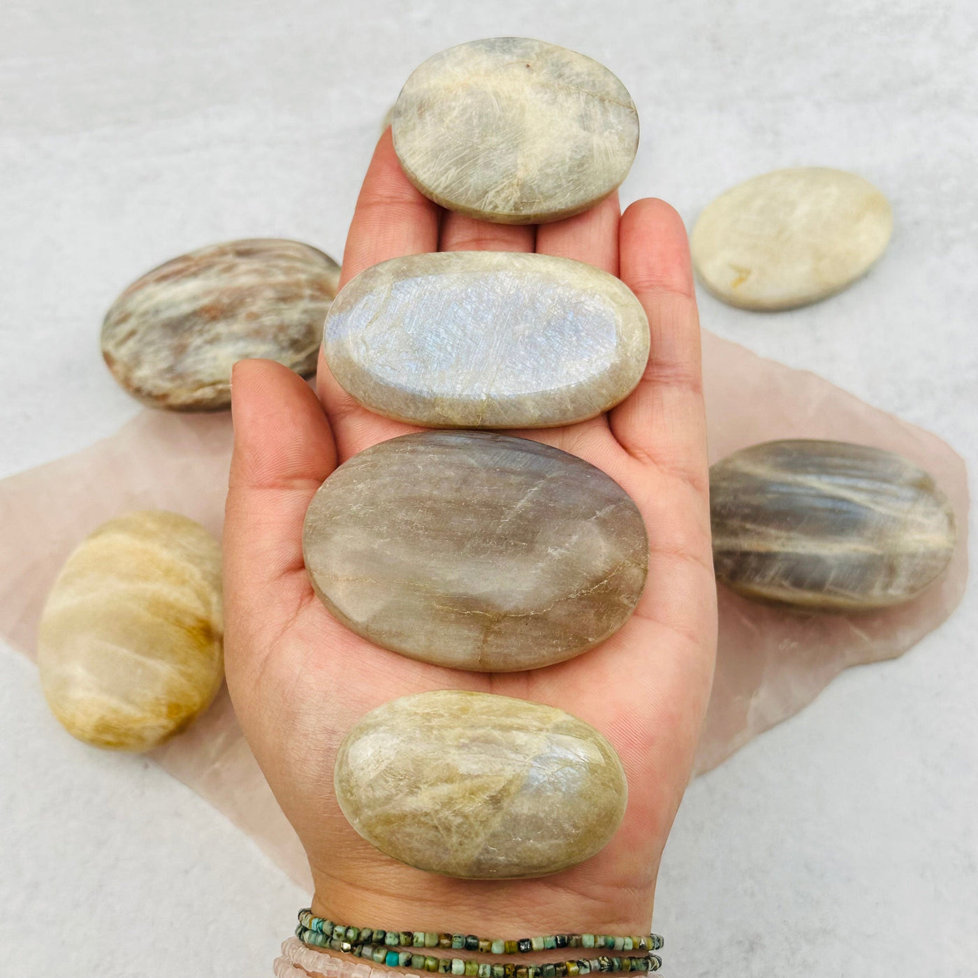 Cream Moonstone Palm Stones in hand for size reference 