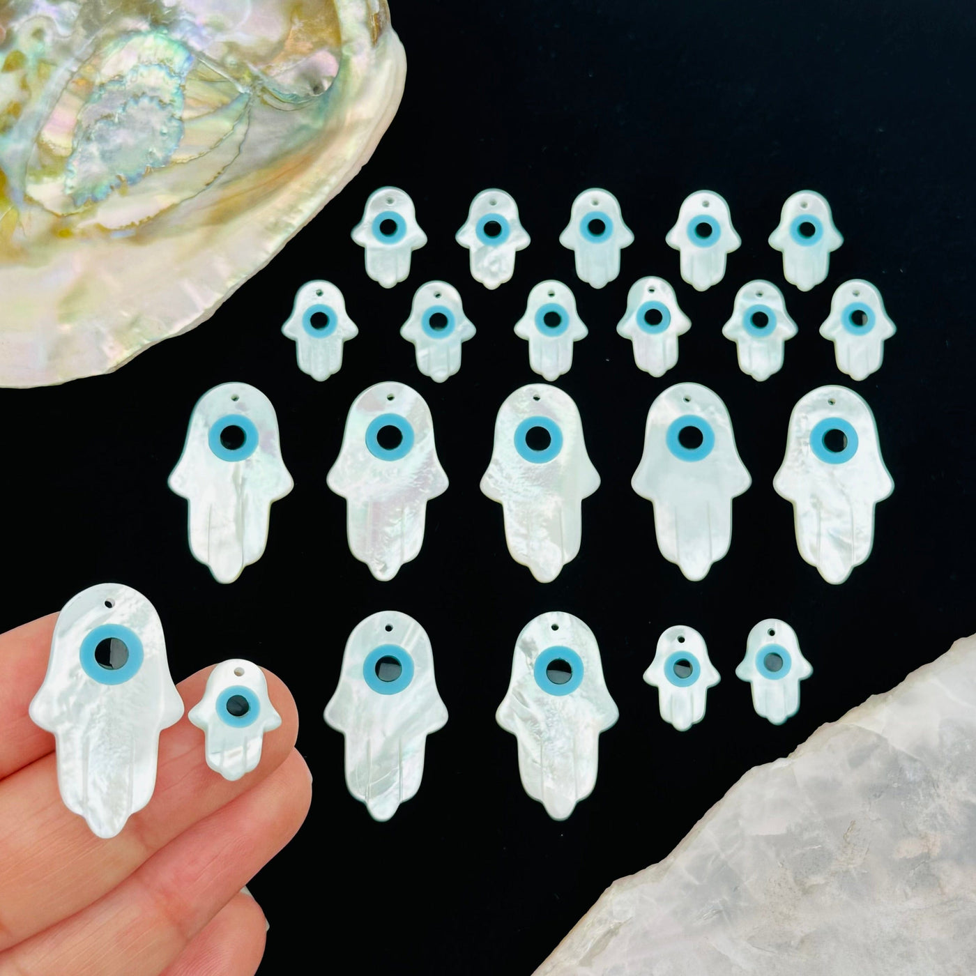 Mother of Pearl Hamsa Hand Eye Drilled Charms on hand for size reference 