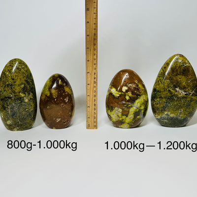Pistachio Green Opal Crystal Polished Cut Base - By Weight - displayed next to a ruler for size reference 