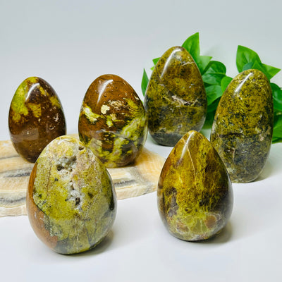 multiple Pistachio Green Opal Crystal Polished Cut Base - By Weight - displayed to show the differences in the sizes and color shades available 