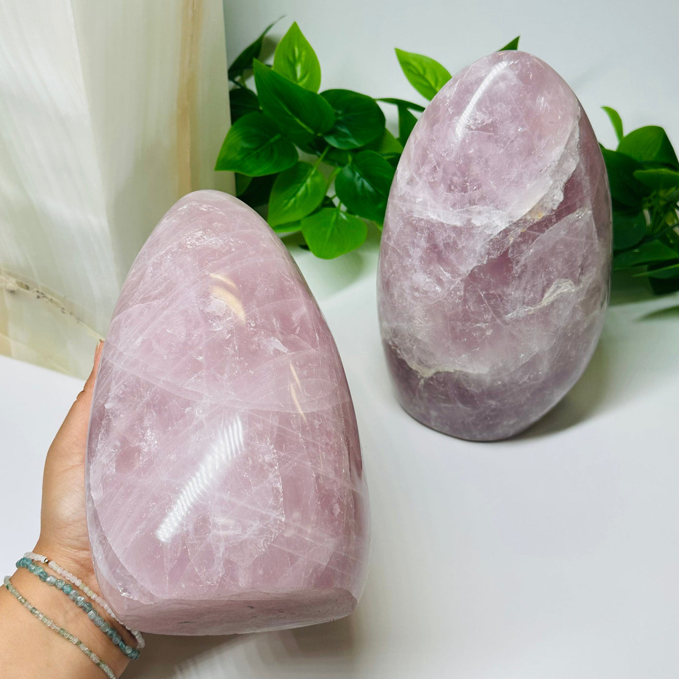 rose quartz crystal cut base in hand for size reference 