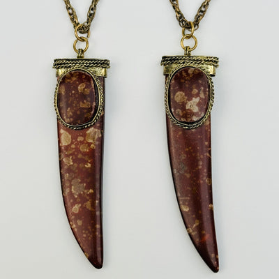 close up of the details on these horn pendants to show the differences in the patterns 