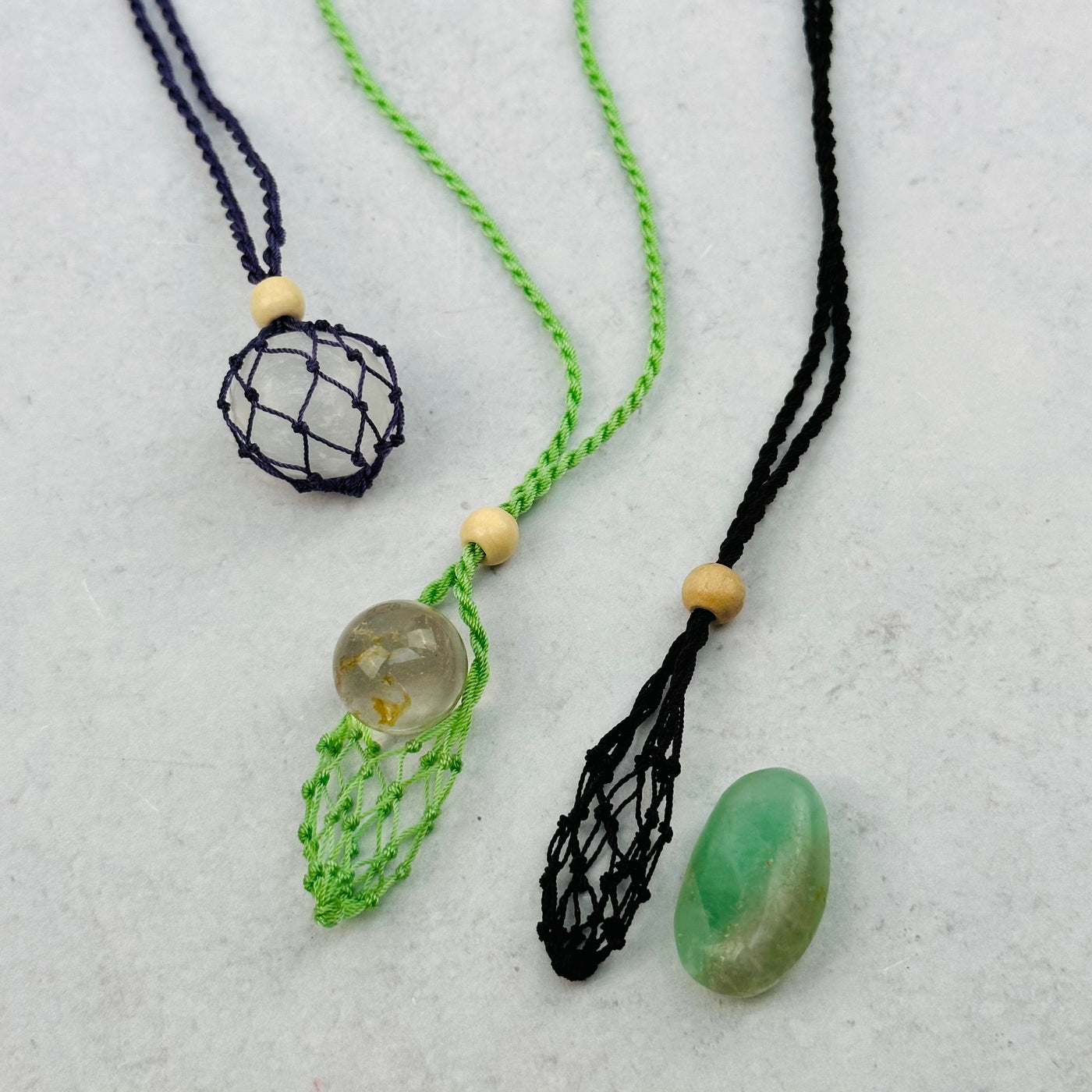 necklaces displayed with some small crystals that can fit in the net