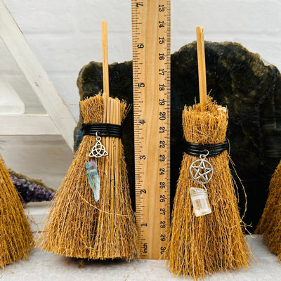 Protection Brooms next to a ruler for size reference 