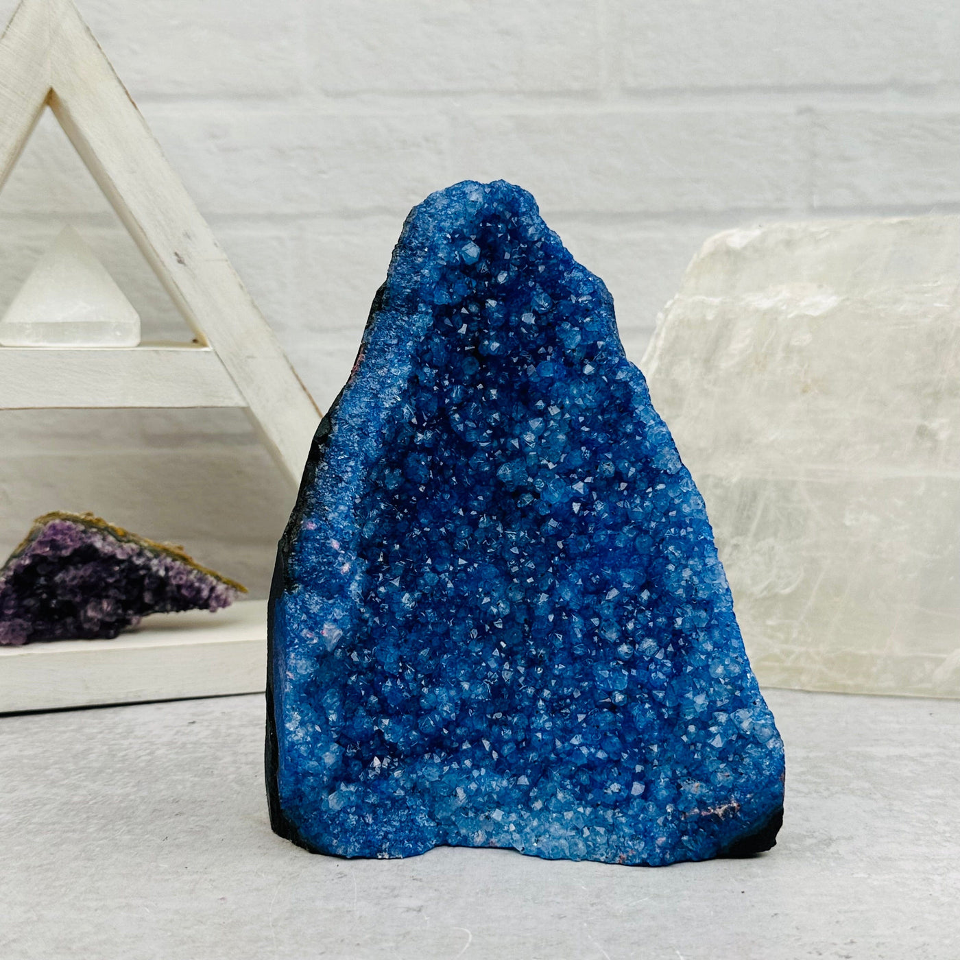 dyed blue Amethyst Crystal Cluster CutBase displayed as home decor 