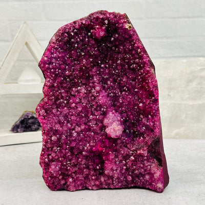 dyed pink Amethyst Crystal Cluster CutBase displayed as home decor 