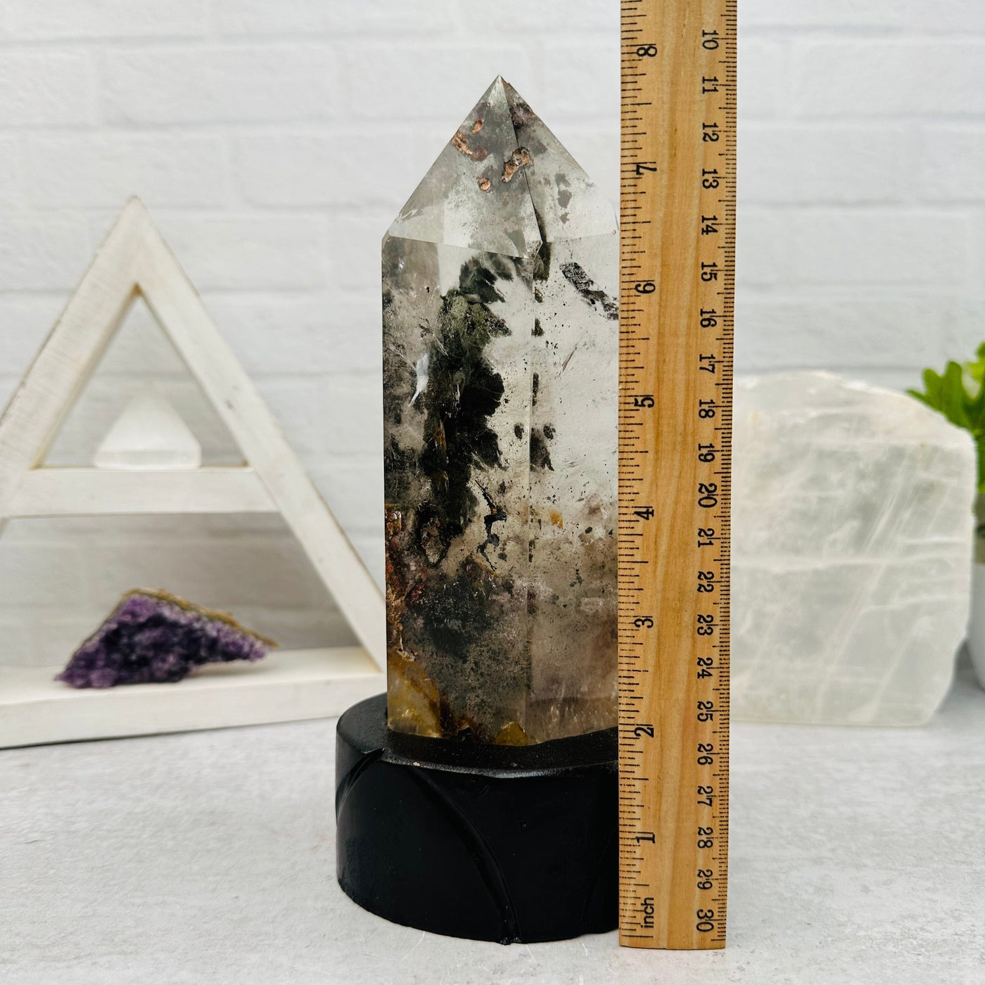  Lodolite Quartz on Wooden Stand next to a ruler for size reference 