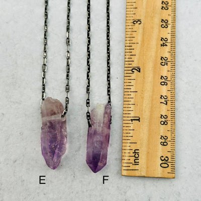 close up of the veracruz amethyst pendants. next to a ruler for size reference