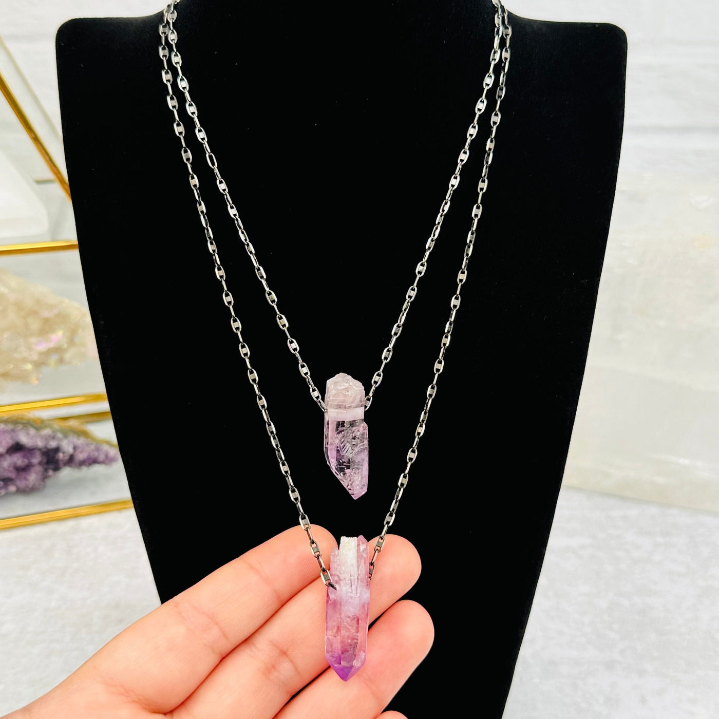 Veracruz Amethyst pendants in hand for size reference 
