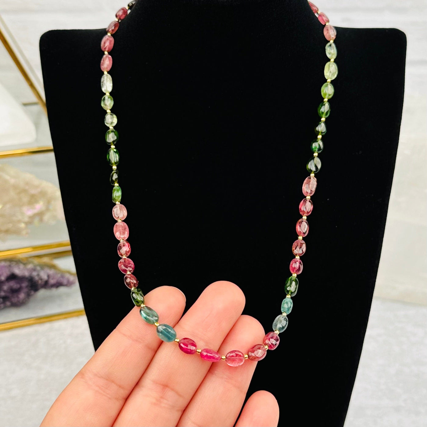 Polished Watermelon Tourmaline Necklace in hand for size reference