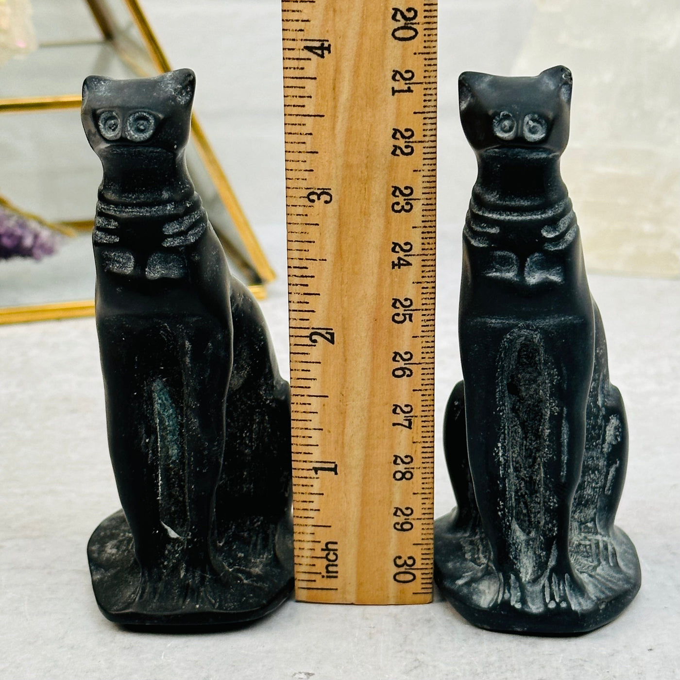 Black Obsidian Cat next to a ruler for size reference