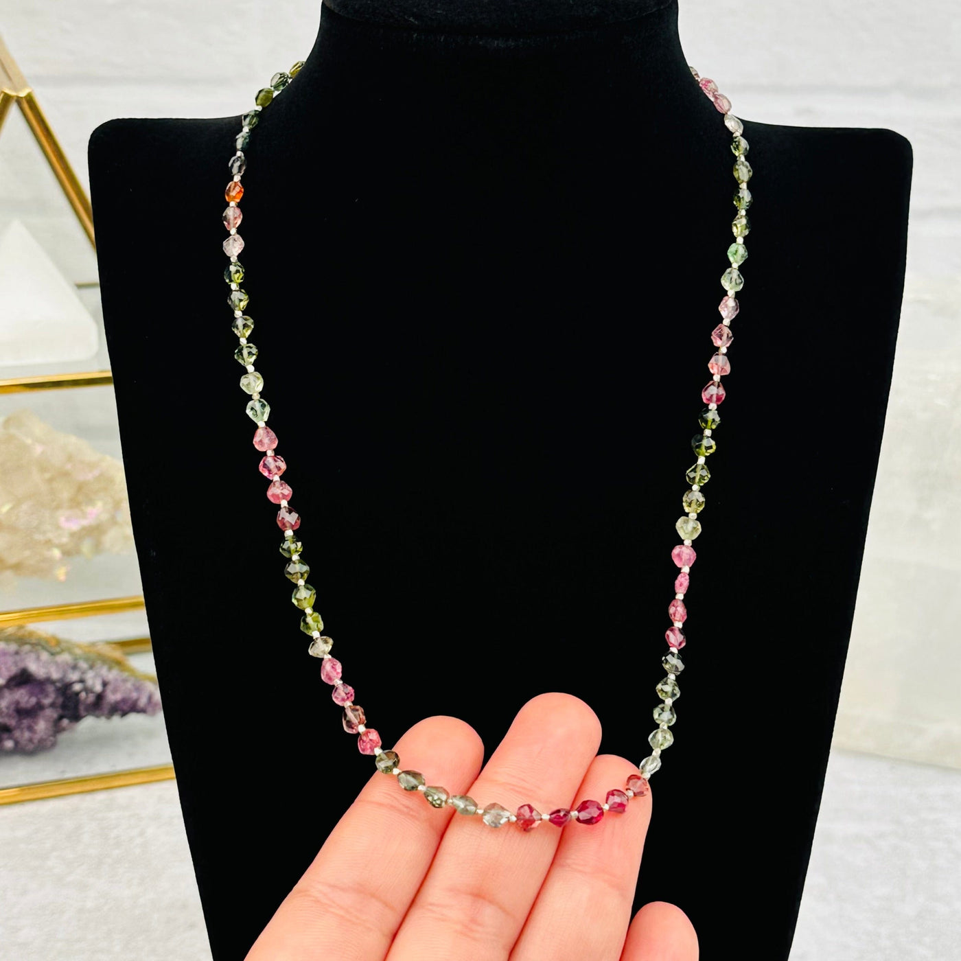 Faceted Watermelon Tourmaline Gemstone Necklace in hand for size reference 