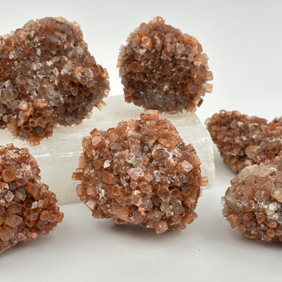 multiple aragonite crystal clusters displayed as home decor 