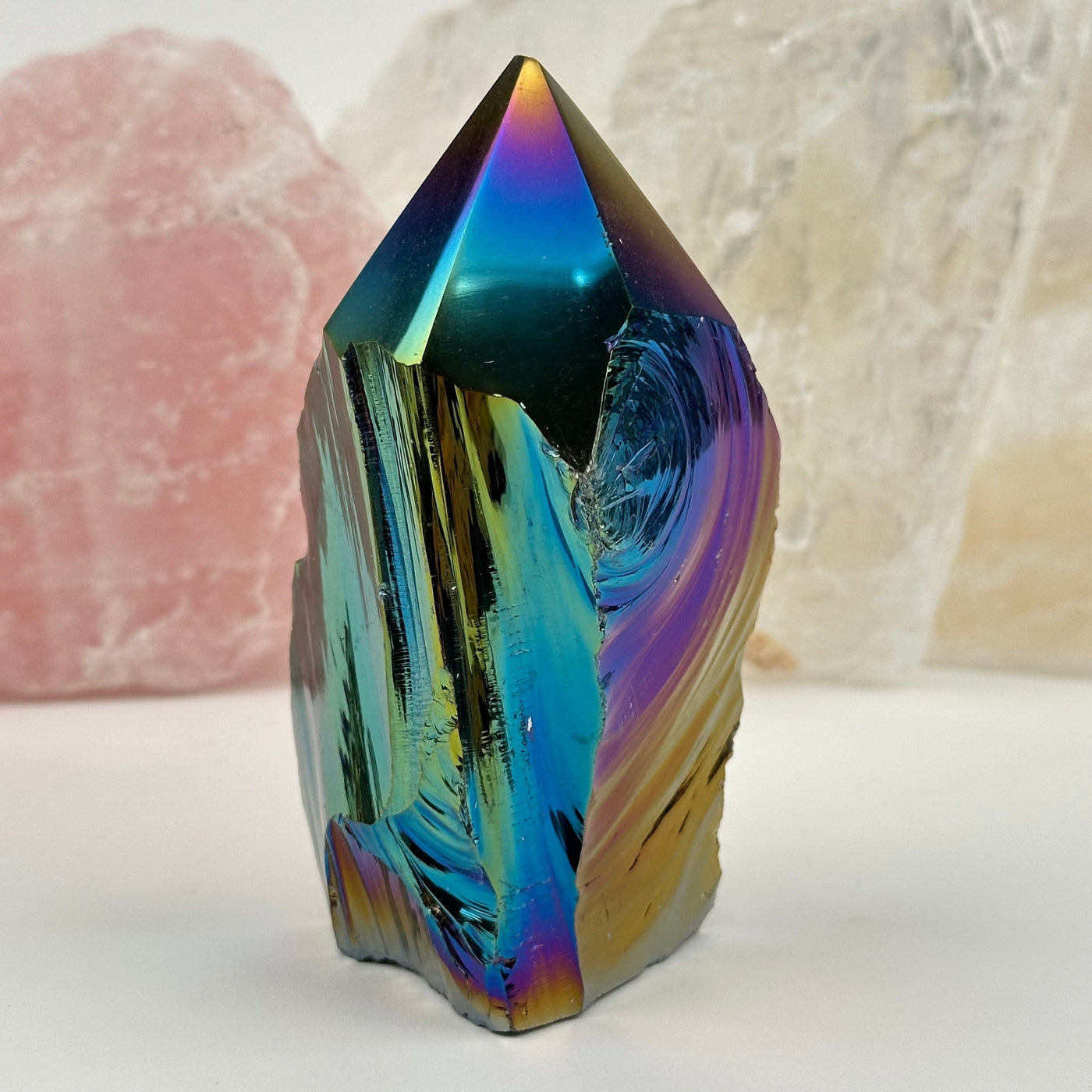 close up of the details on this crystal point that has been rainbow titanium coated 