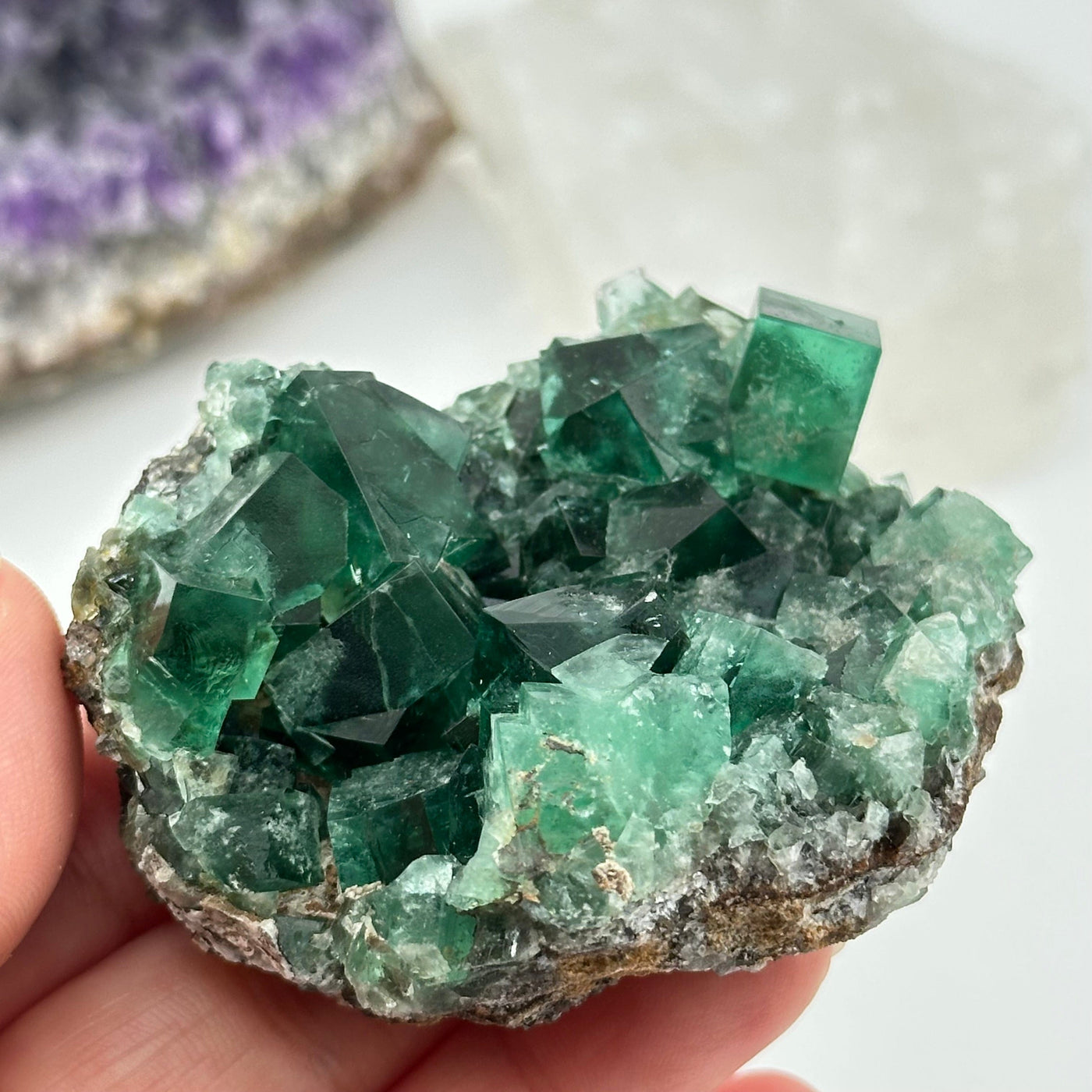 crystal cluster in hand for size reference 