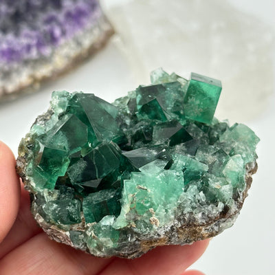 crystal cluster in hand for size reference 