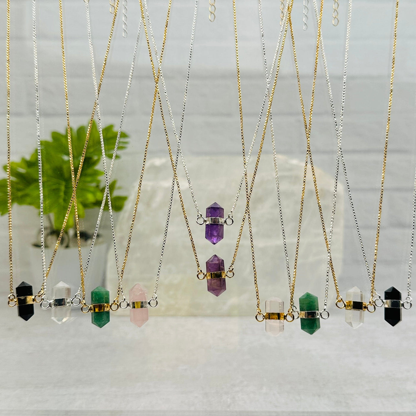 multiple necklaces displayed to show the differences in the gemstone types