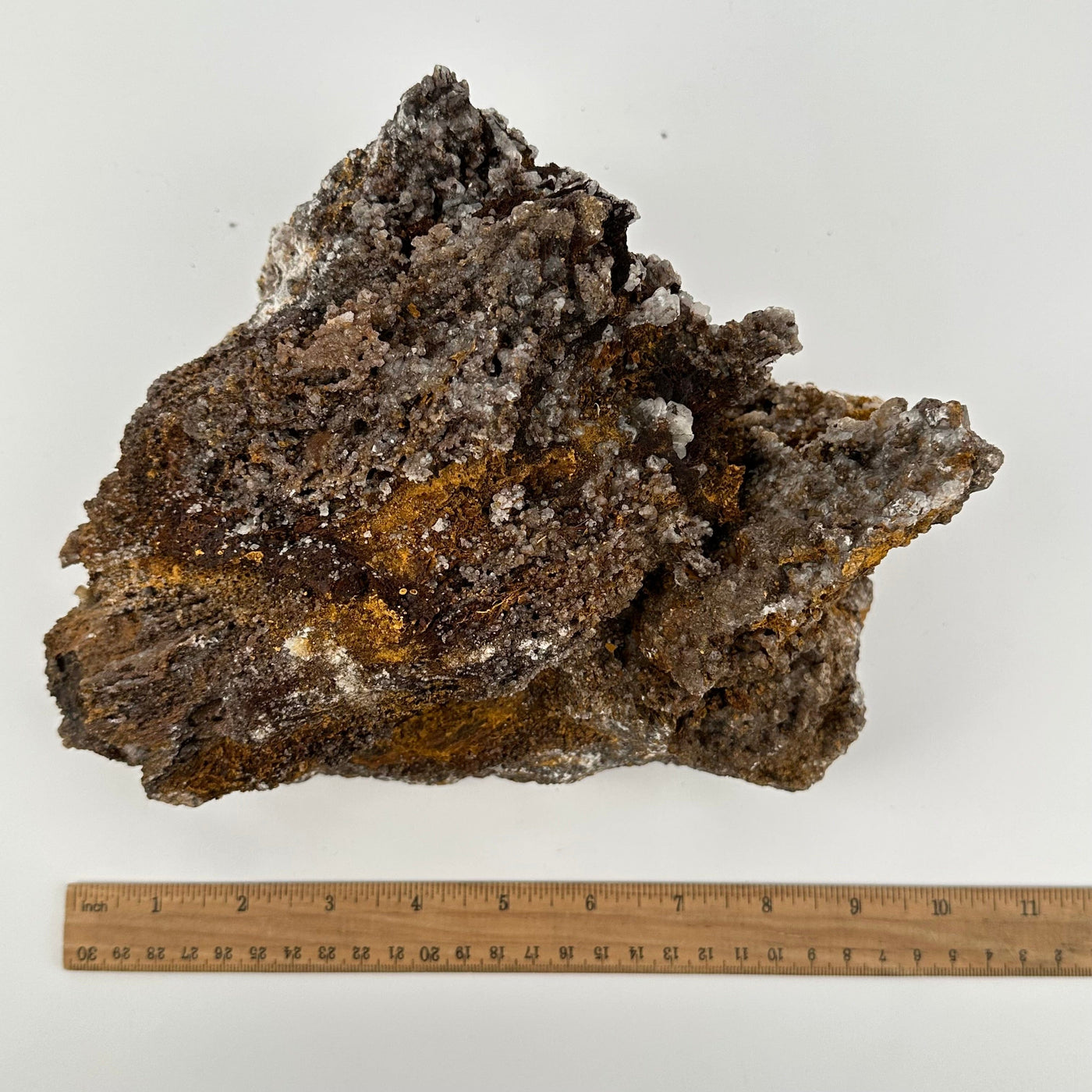 crystal cluster displayed next to a ruler for size reference 