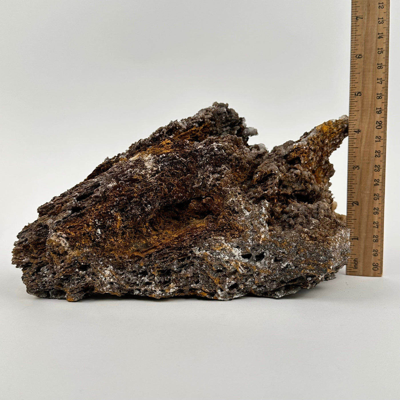 crystal cluster displayed next to a ruler for size reference 